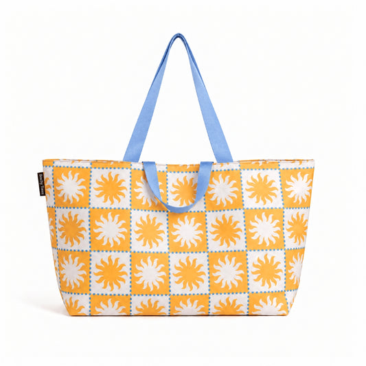 Golden Rays XL beach bag in an orange and white sun checkerboard with blue handles